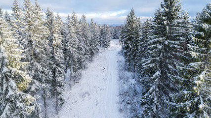 top view of snowy winter forest and road