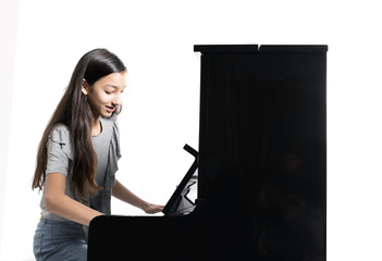 teenage brunette girl and black upright piano in studio © ahavelaar