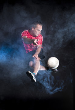 Studio portrait of sportsmen using balls
