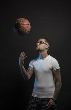 Studio portrait of sportsmen using balls