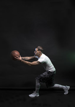 Studio portrait of sportsmen using balls
