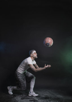 Studio portrait of sportsmen using balls