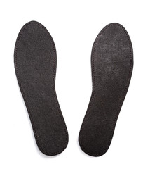 Pair of black insoles for shoes isolated on white background.