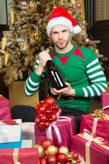 Obraz na płótnie Canvas Macho in elf costume with champagne bottle
