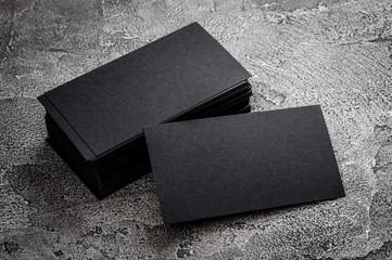 Black paper business card template on grey background. Blank name card for text space.