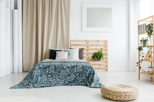 Bed with patterned blue coverlet