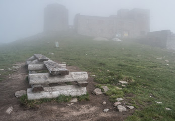 Mist landscape with old abandoned observatory on mount Pip Ivan in Carpathian mountains