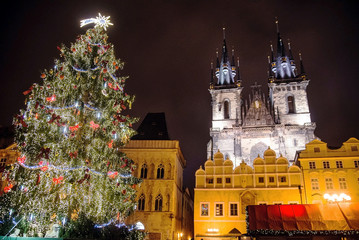 Christmas tree in square behind old tower