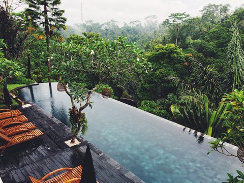 View of deck chairs by infinity pool