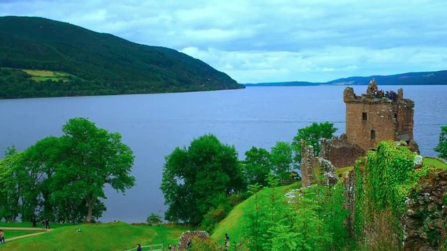 August 2017: Tourists watching the lochness from an Urquhart Castle tower. August 2017 in Drumnadrochit