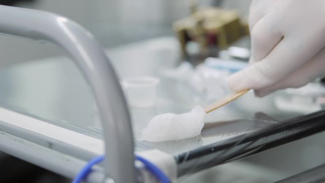 Putting vaseline on a tattoo table - Tattooing Preparation. Slow motion.