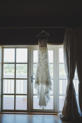 White wedding dress on a window frame
