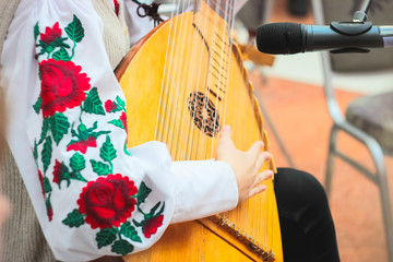Woman playing music with balalaika. Lifestyle concept. Russian instrument.