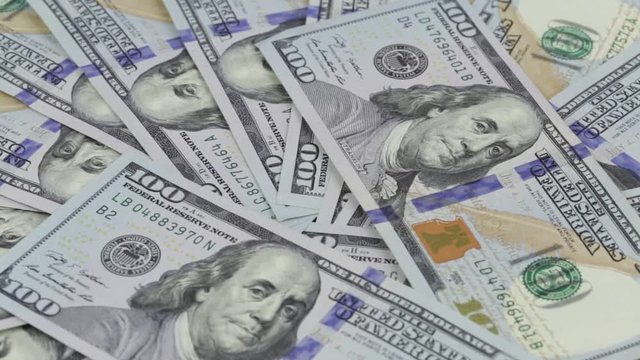 Rotation and falling paper money close-up. Background with money american hundred dollar bills