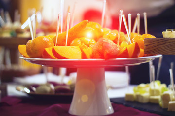 Bananas, apples, pineapple, oranges. Assorted fruits on the plate