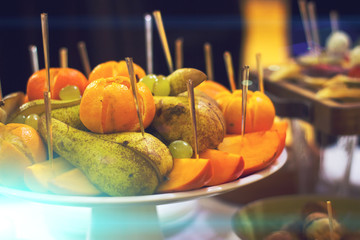 apples, pineapple, oranges. Assorted fruits on the plate