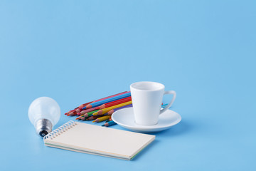 Pile of colour pencils on light blue background, creative idea concept