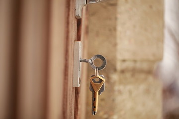 key in the lock of the wooden door