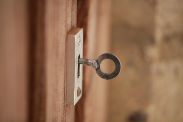 key in the lock of the wooden door