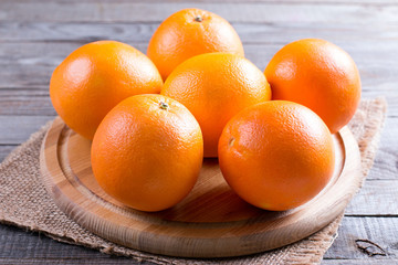 Six oranges on a cutting board