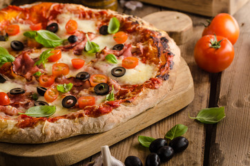 Rustic pizza with tomato, cheese, salami