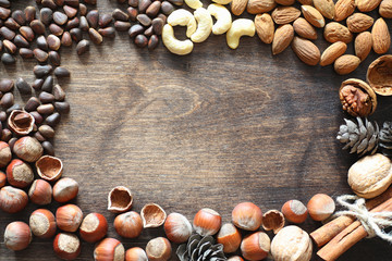 Different nuts on a wooden table. Cedar, cashew, hazelnut, walnu