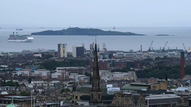 August 2017: Panorama of the port of Edinburgh, Inchkeith Island and a cruise ship ready to moor. August 2017 in Edimburgh