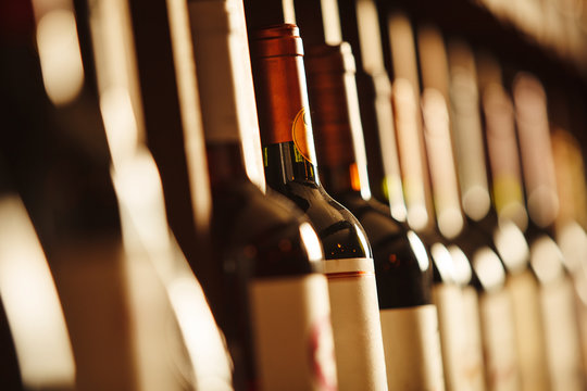 Wine cellar with elite drinks on shelves with written names