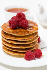 stack of pancakes with raspberries for breakfast, vertical closeup