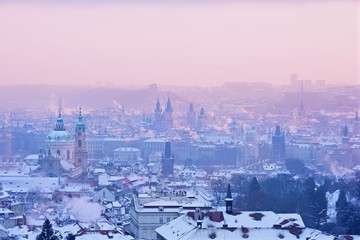 Winter Prague Panorama with Snowy Towers and Roofs