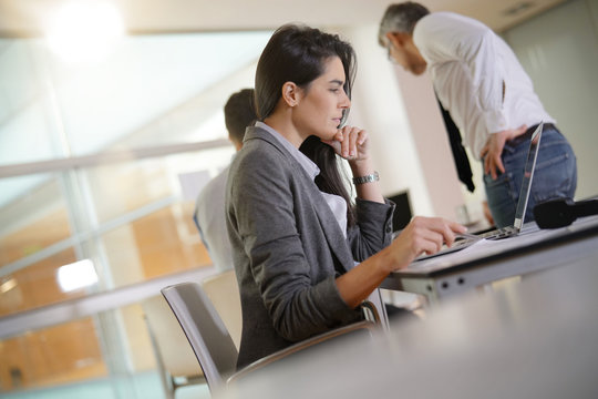 Businesswoman working in office on laptop computer