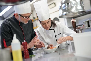 Foto op Plexiglas Professional cook chefs in kitchen improving dish composition © goodluz