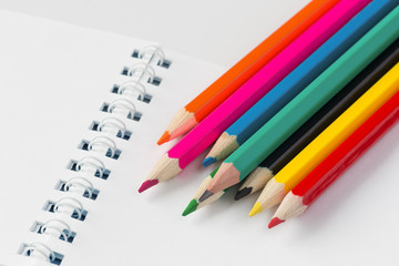 Color pencils and open notebook