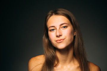 Portrait beautiful girl on a dark studio background