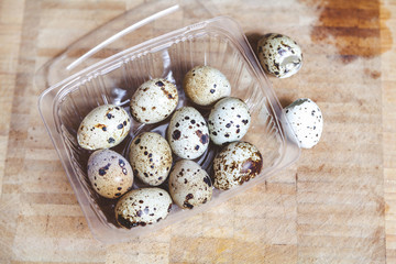 Quail eggs lie in a transparent box