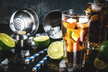 Cuba Libre, long island or iced tea cocktail with strong alcohol, cola, lime and ice, two glass,...