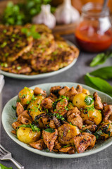 Potato pancakes, fried chicken with potatoes