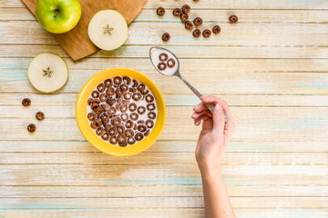 Chocolate cereal flakes rings with milk top view