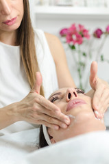 Obraz na płótnie Canvas Mild face massage with vitamin cream