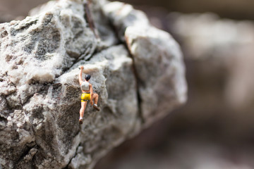 Miniature people : Women are playing high climbing sport. Used as a background for holiday adventure travel business concept.