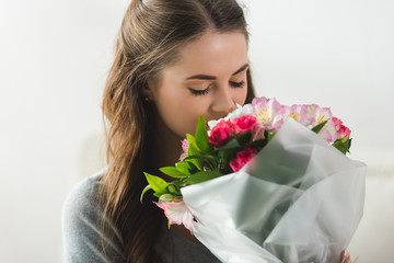 sensual young woman with beautiful flower bouquet