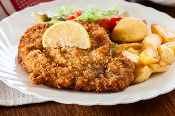 Breaded viennese schnitzel with baked potatoes