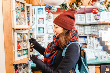 woman tourist buys souvenirs and gifts at the Christmas market in Prague