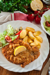 Breaded viennese schnitzel with baked potatoes