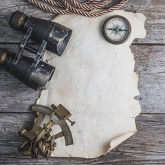 vintage card with compass and others measurement instruments on the wooden timber