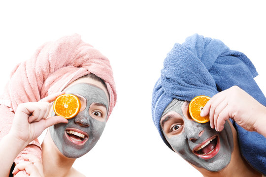 A Guy With A Girl Looks At The Camera And Hold Orange Slices Near The Face , Mask For Skin Man And Woman, Guy With A Girl Make A Mask For The Skin Together, Funny Couple Of Lovers,  Isolated Photo,