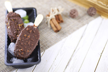 Dessert chocolate ice cream with nuts on wooden stick