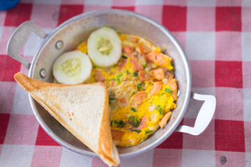 Pan fried egg with toppings is breakfast of Asian food