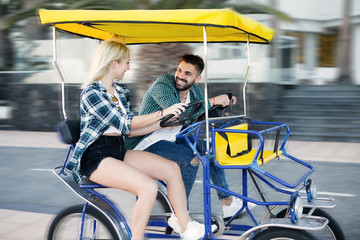 Obraz na płótnie Canvas Couple riding fast in cart