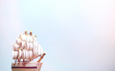 Old wooden ship with sails and masts toy on a stand. Vintage and
